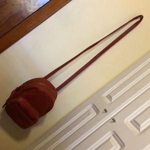 Dark orange purse/backpack convertible. Never used. Big pocket space.